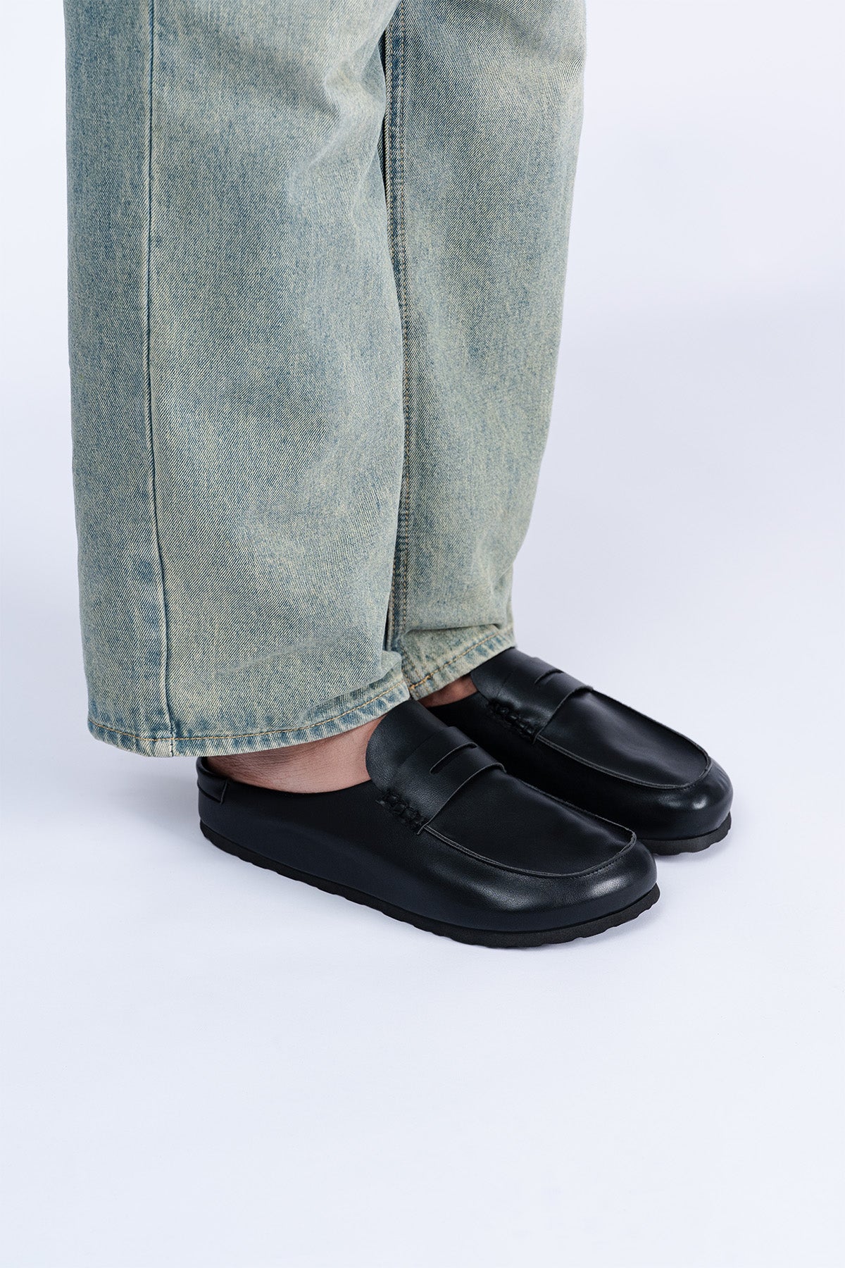 Black Saaplay Birkener Moccas showing the textured leather upper and classic moccasin design on a neutral background.