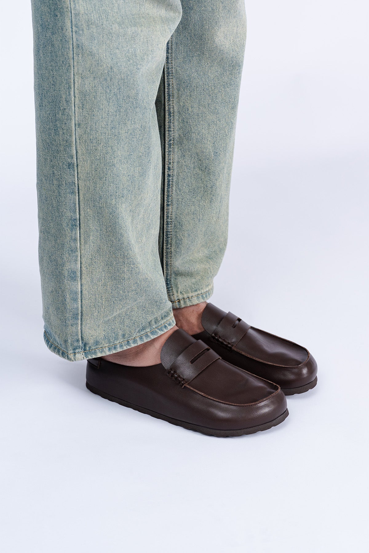 Brown Saaplay Birkener Moccas shoes with leather upper and moccasin design, shown on a neutral background.
