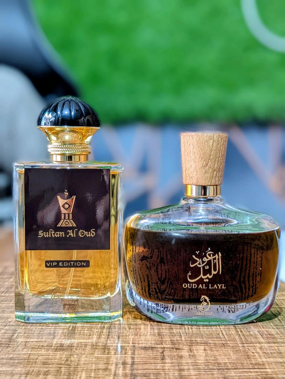 Pak Sultan al Oud and Oud al Lail perfume bottles, elegant fragrance packaging with golden accents and floral design.
